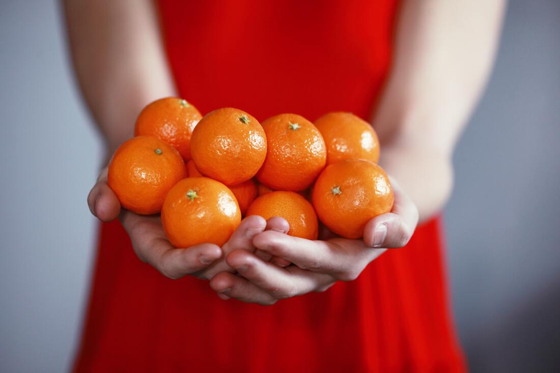 Woman Holding Oranges